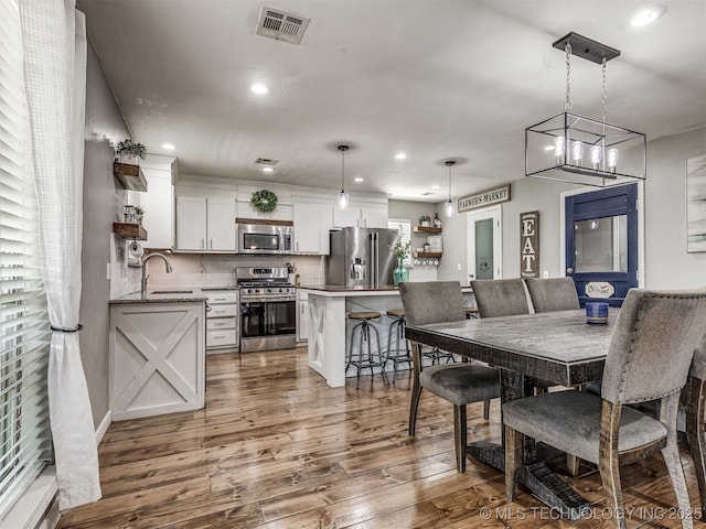 dining space featuring dark wood finished floors and recessed lighting