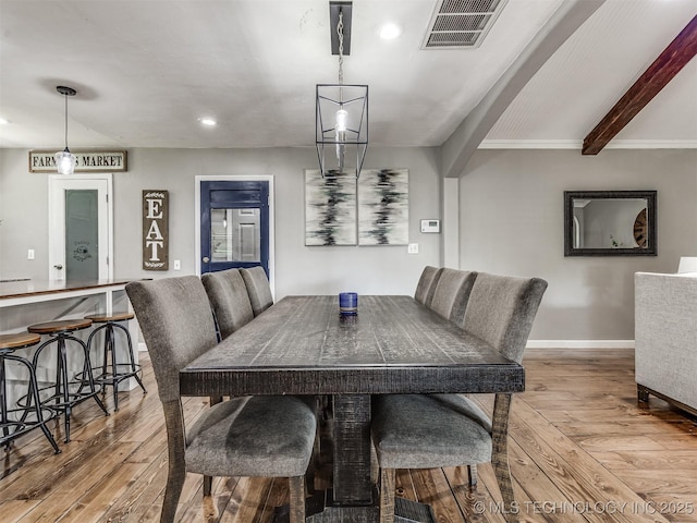 dining area featuring hardwood / wood-style floors, baseboards, recessed lighting, and beamed ceiling