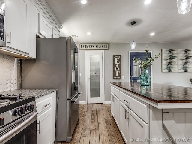 kitchen featuring white cabinets, tasteful backsplash, dark wood-type flooring, recessed lighting, and wooden counters