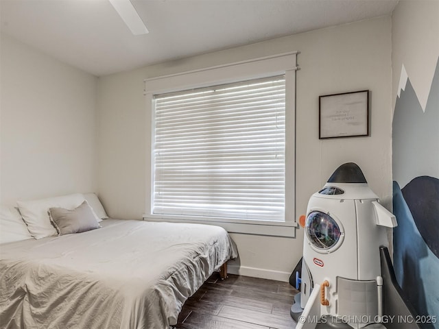 bedroom featuring wood finished floors, baseboards, multiple windows, and a ceiling fan