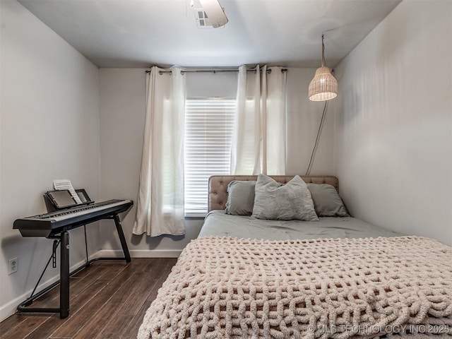 bedroom featuring dark wood finished floors and baseboards