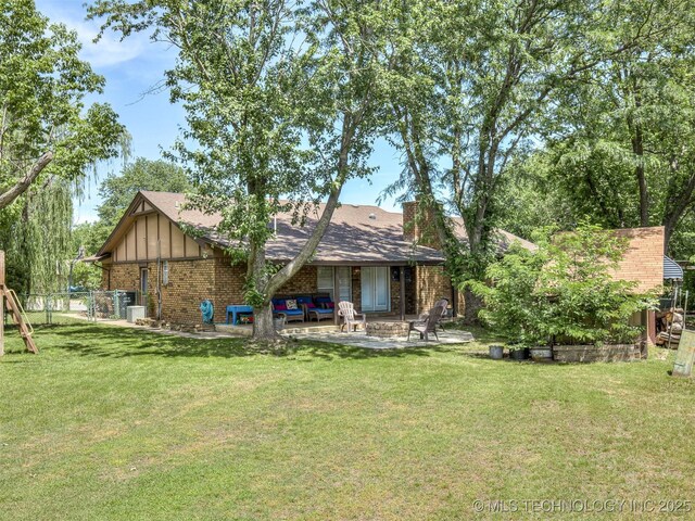 back of house featuring brick siding and a patio area