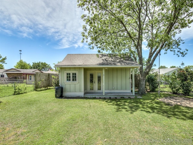 rear view of house featuring board and batten siding, french doors, an outdoor structure, and roof with shingles