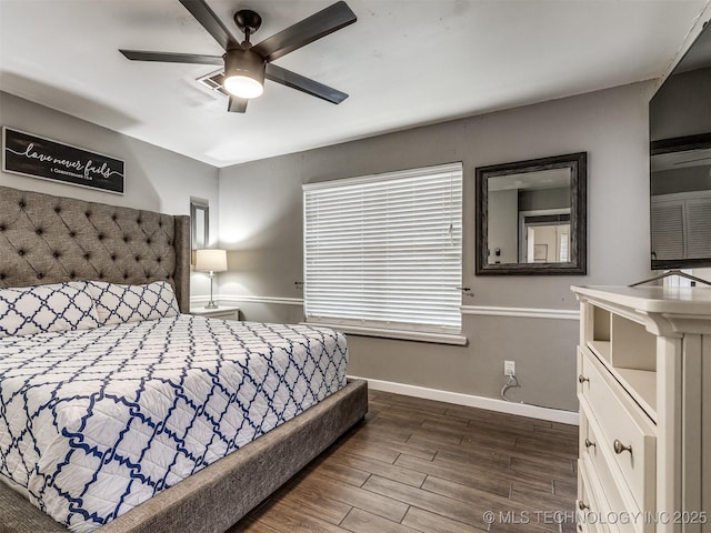 bedroom featuring dark wood-type flooring, baseboards, and ceiling fan