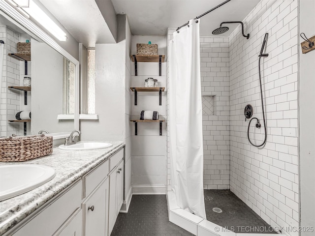 bathroom featuring tile patterned floors, a shower stall, and double vanity