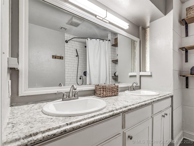 full bathroom featuring curtained shower and double vanity
