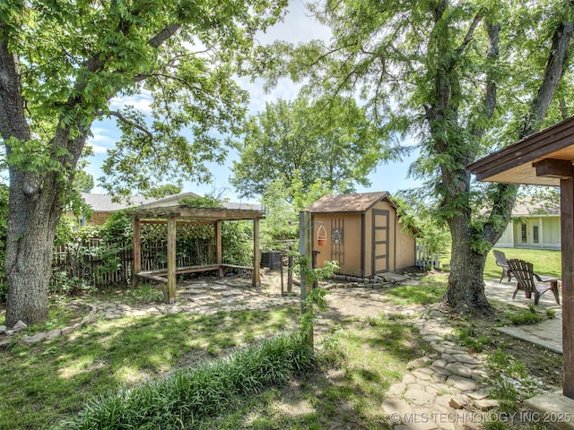 view of yard with a storage shed, an outdoor structure, and fence