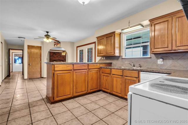 2750 Enterprise, Lone Grove, OK 73401 - kitchen with white appliances, a peninsula, tasteful backsplash, and brown cabinetry
