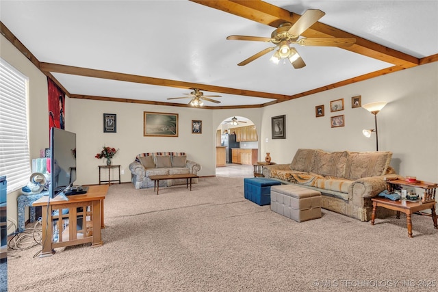 2750 Enterprise, Lone Grove, OK 73401 - living room with beam ceiling, carpet, arched walkways, and a ceiling fan