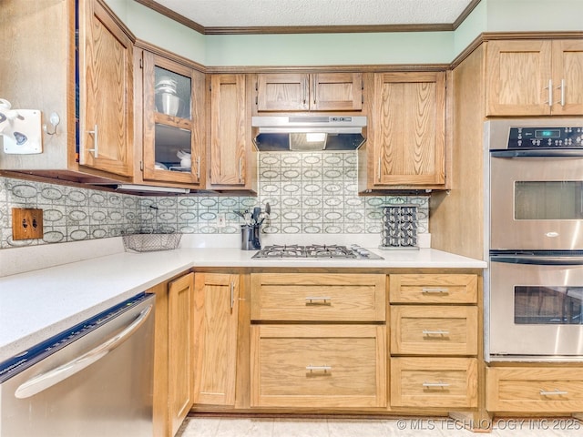 3931 S Oswego Ave, Tulsa, OK 74135 - kitchen featuring stainless steel appliances, under cabinet range hood, light countertops, decorative backsplash, and glass insert cabinets