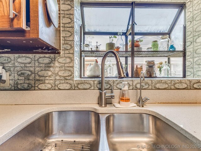 3931 S Oswego Ave, Tulsa, OK 74135 - kitchen view of a sink, tasteful backsplash, and light countertops