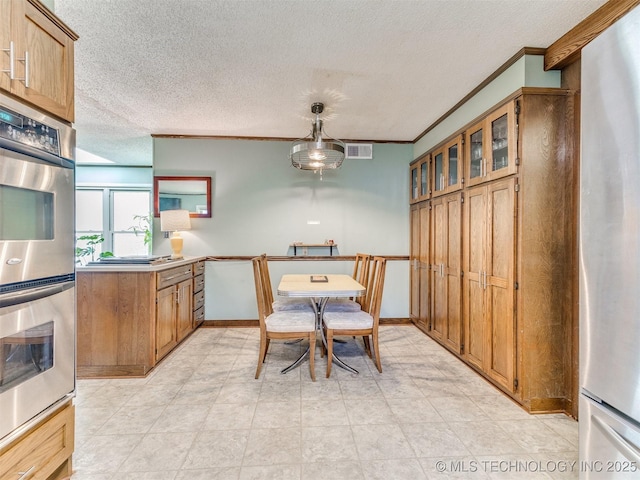 3931 S Oswego Ave, Tulsa, OK 74135 - dining area featuring ornamental molding and a textured ceiling