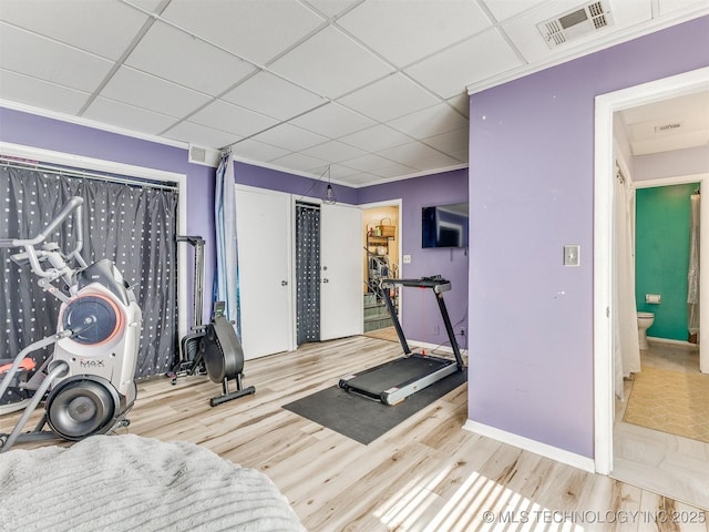3931 S Oswego Ave, Tulsa, OK 74135 - workout area with a paneled ceiling, wood finished floors, and baseboards