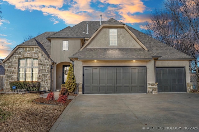9475 E 107th Pl S, Bixby, OK 74133 - view of front of property with stone siding, an attached garage, stucco siding, and driveway
