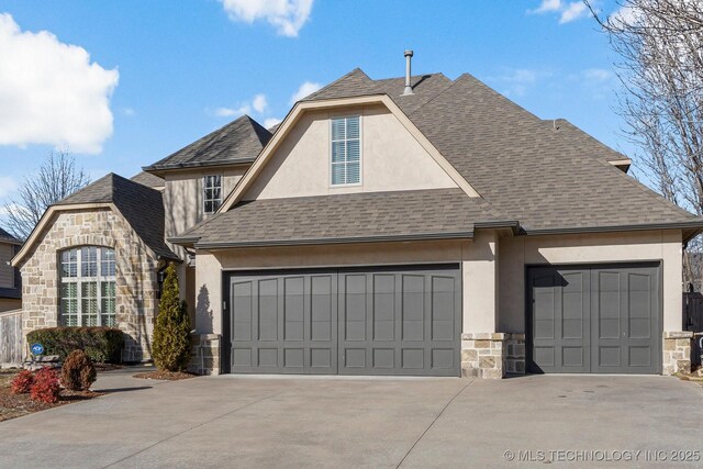 9475 E 107th Pl S, Bixby, OK 74133 - view of front of house with stone siding, stucco siding, driveway, an attached garage, and roof with shingles