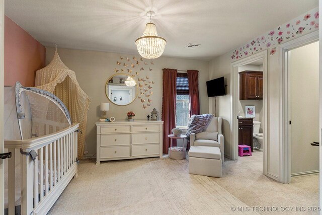 9475 E 107th Pl S, Bixby, OK 74133 - bedroom featuring a chandelier, light colored carpet, a nursery area, baseboards, and ensuite bathroom