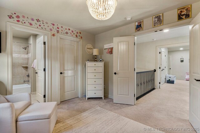 9475 E 107th Pl S, Bixby, OK 74133 - bedroom featuring a chandelier, light carpet, ensuite bath, and baseboards