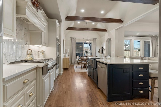 9475 E 107th Pl S, Bixby, OK 74133 - kitchen featuring a sink, healthy amount of natural light, dark cabinets, decorative backsplash, and recessed lighting