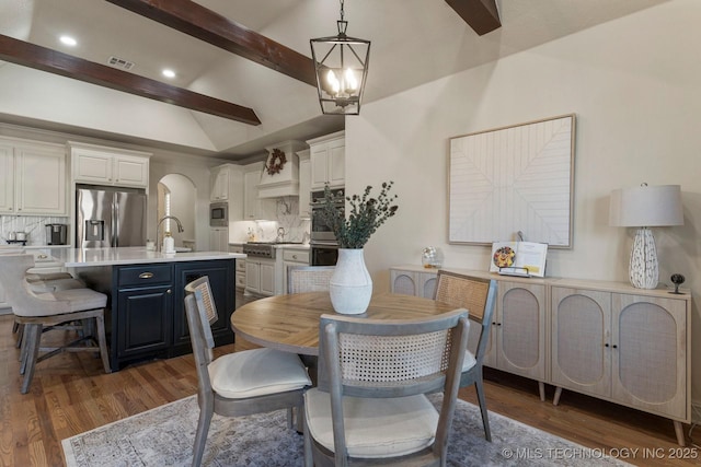 9475 E 107th Pl S, Bixby, OK 74133 - dining room featuring arched walkways, wood finished floors, recessed lighting, and a chandelier