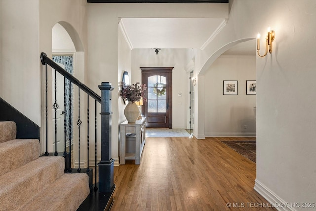 9475 E 107th Pl S, Bixby, OK 74133 - foyer with ornamental molding, wood finished floors, baseboards, arched walkways, and stairs