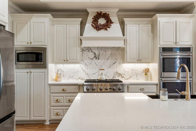 9475 E 107th Pl S, Bixby, OK 74133 - kitchen featuring appliances with stainless steel finishes, a sink, custom exhaust hood, tasteful backsplash, and crown molding