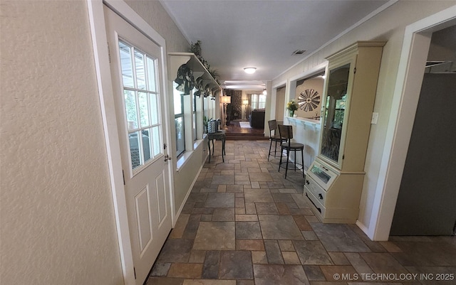 5328 Monroe Rd, Kingston, OK 73439 - corridor with stone tile floors, plenty of natural light, and a textured wall
