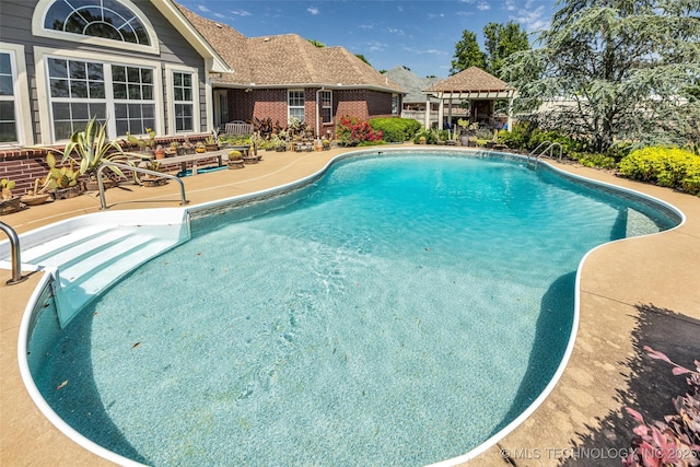 swimming pool featuring a gazebo and a patio