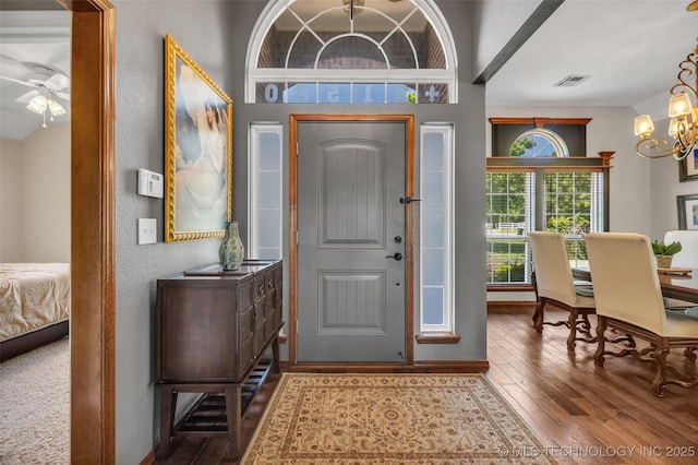 entryway featuring a chandelier, wood-type flooring, and ceiling fan