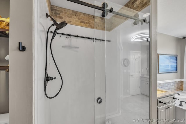 full bathroom featuring a shower stall, vanity, and tile patterned flooring