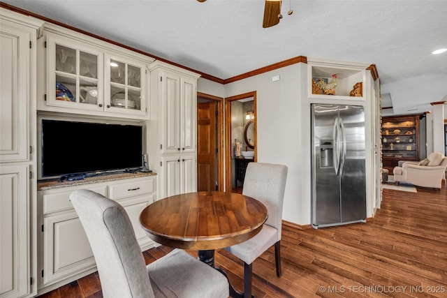 dining area featuring wood finished floors, crown molding, baseboards, and recessed lighting