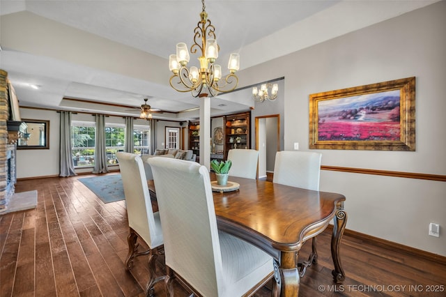 dining area with wood finished floors, baseboards, a ceiling fan, and a raised ceiling