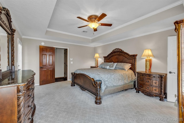 bedroom with a tray ceiling, light carpet, ornamental molding, and ceiling fan