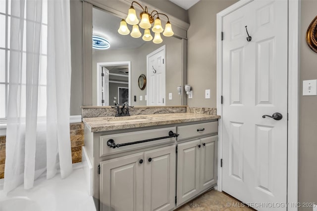 bathroom featuring a chandelier and vanity