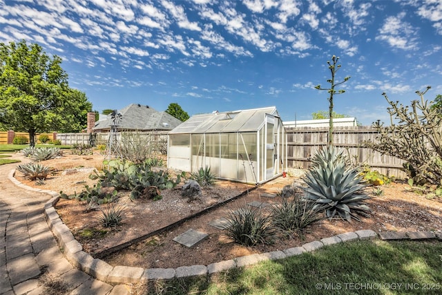 fenced backyard featuring an exterior structure and an outbuilding