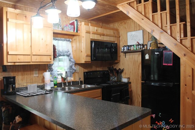 6363 S Brewer Rd, Kiowa, OK 74553 - kitchen with black appliances, a sink, open shelves, dark countertops, and wood walls