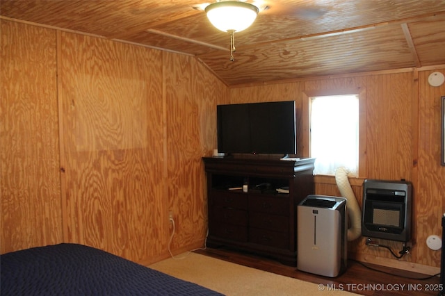 6363 S Brewer Rd, Kiowa, OK 74553 - bedroom featuring heating unit, wood ceiling, vaulted ceiling, wood finished floors, and wooden walls