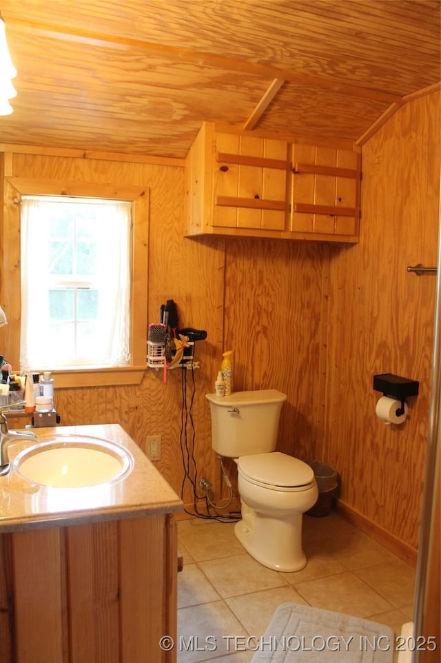 6363 S Brewer Rd, Kiowa, OK 74553 - half bath with wooden ceiling, tile patterned floors, toilet, wooden walls, and vanity