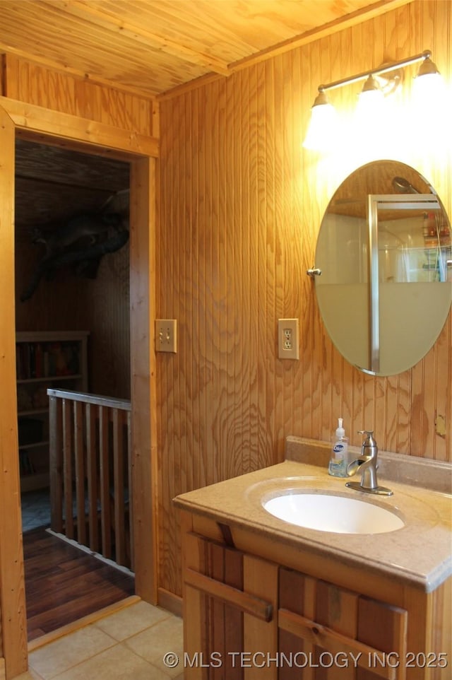 6363 S Brewer Rd, Kiowa, OK 74553 - bathroom featuring wood walls, wood ceiling, tile patterned flooring, and vanity
