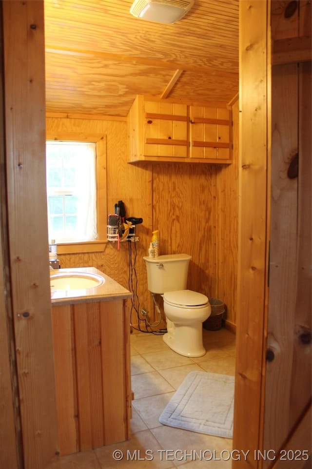 6363 S Brewer Rd, Kiowa, OK 74553 - half bath featuring wood ceiling, toilet, vanity, tile patterned floors, and wood walls