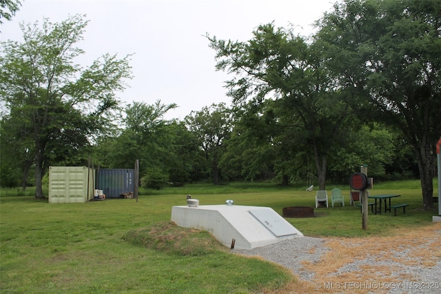 6363 S Brewer Rd, Kiowa, OK 74553 - entry to storm shelter featuring a lawn