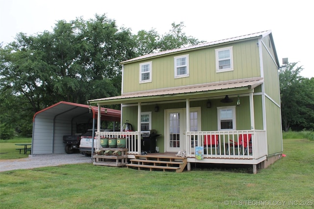 6363 S Brewer Rd, Kiowa, OK 74553 - farmhouse featuring a front lawn, gravel driveway, a detached carport, metal roof, and a porch