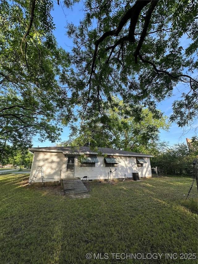 back of house with a lawn