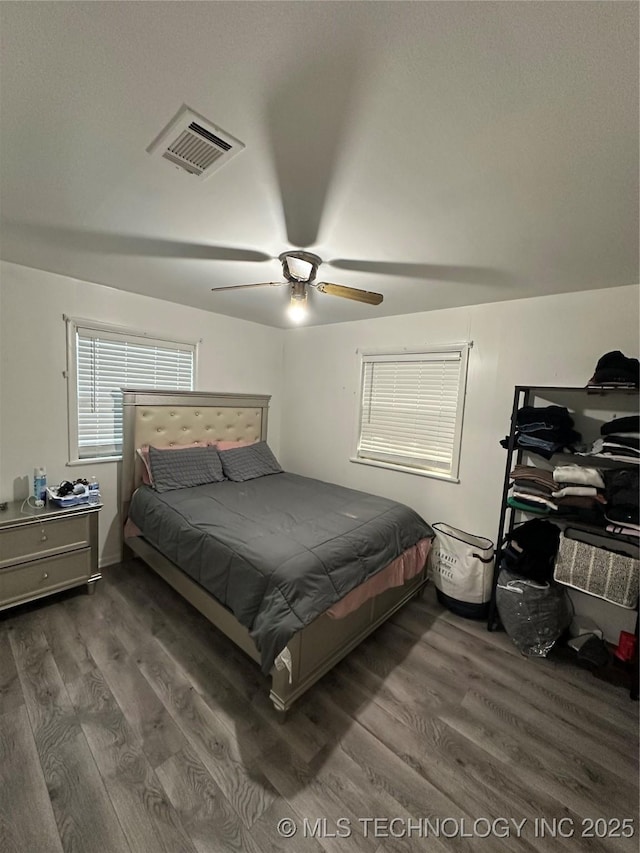 bedroom featuring dark wood-style flooring and ceiling fan