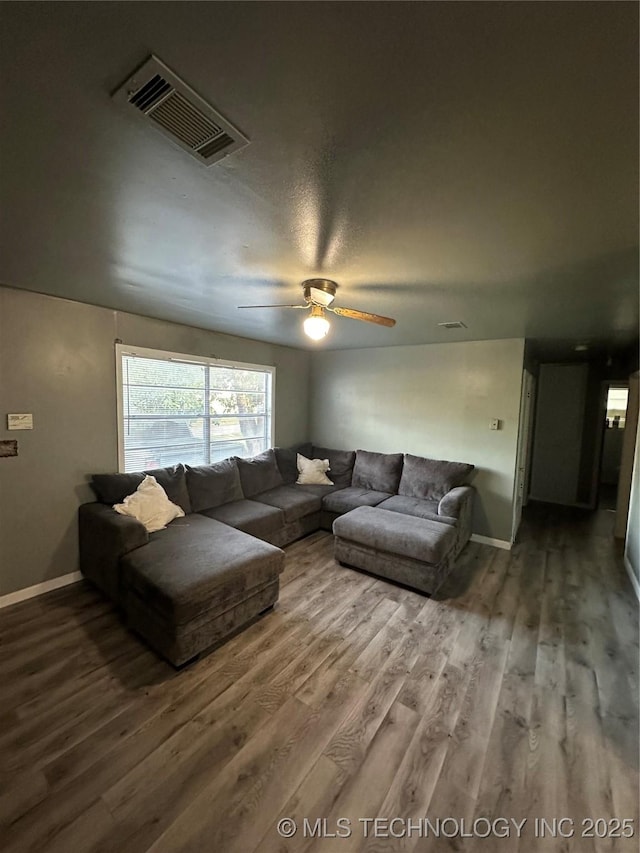 living room with wood finished floors, baseboards, and a ceiling fan