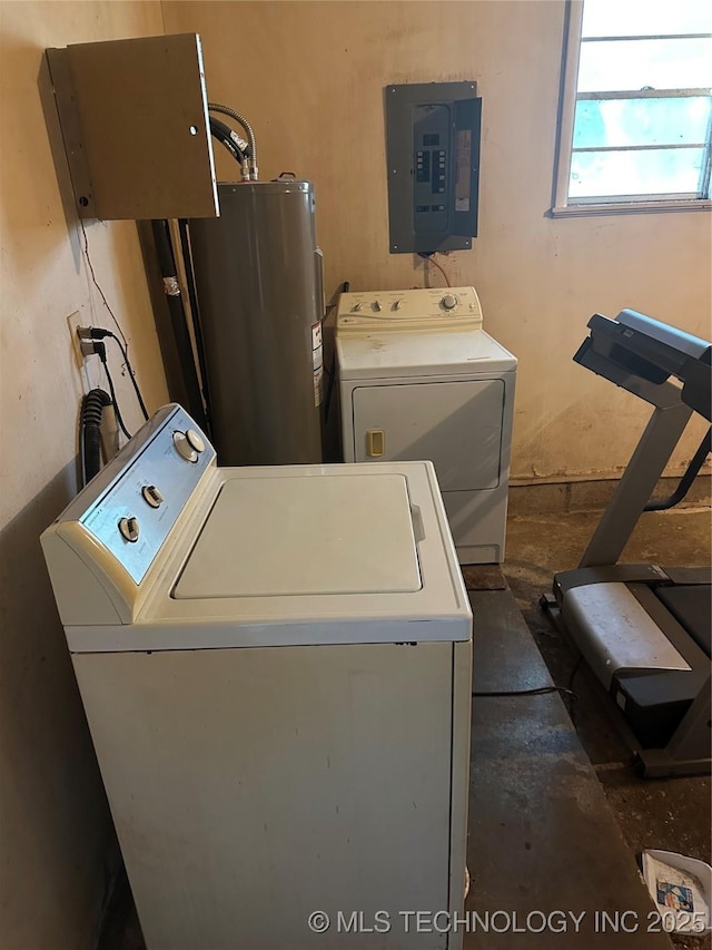 clothes washing area with electric panel, water heater, and washer and clothes dryer
