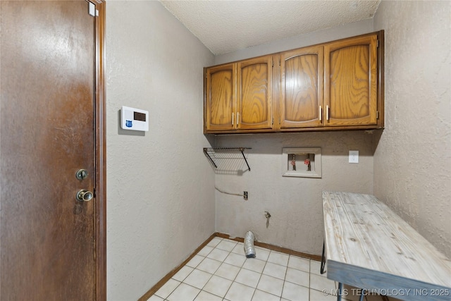 laundry room with cabinet space, hookup for a gas dryer, washer hookup, baseboards, and a textured ceiling