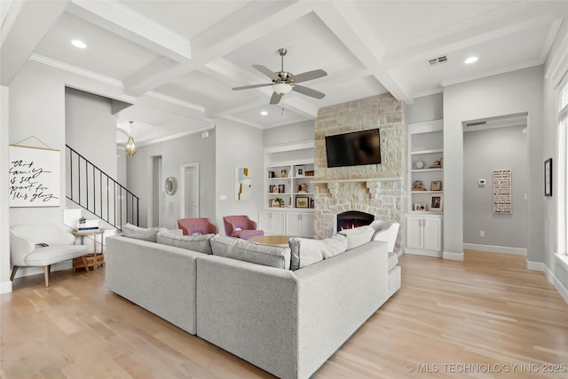 12113 S Fulton Ave E, Bixby, OK 74008 - living area with light wood-type flooring, a fireplace, ceiling fan, coffered ceiling, and beamed ceiling