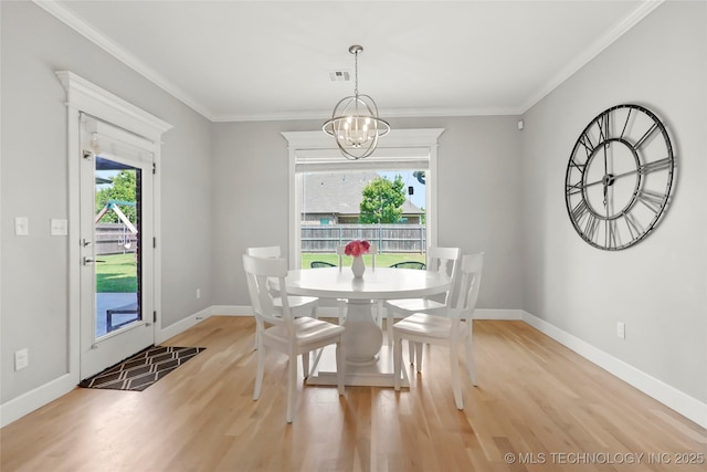 12113 S Fulton Ave E, Bixby, OK 74008 - dining room with plenty of natural light, a chandelier, wood finished floors, and crown molding