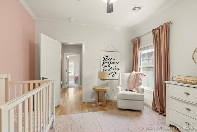 12113 S Fulton Ave E, Bixby, OK 74008 - sitting room featuring crown molding, plenty of natural light, light wood-style floors, an upstairs landing, and ceiling fan