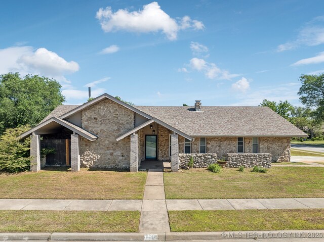 6505 E 47th St, Tulsa, OK 74145 - view of front facade with a front lawn, roof with shingles, and stone siding